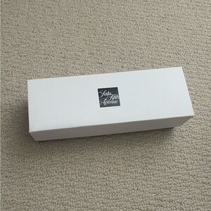 Saks Fifth Avenue black and white gift box with tissue paper